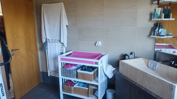 Salle de bain du rez-de-chaussée avec meuble vasque, rangements et espace bien-être dans la maison à vendre à Saint-Bernard